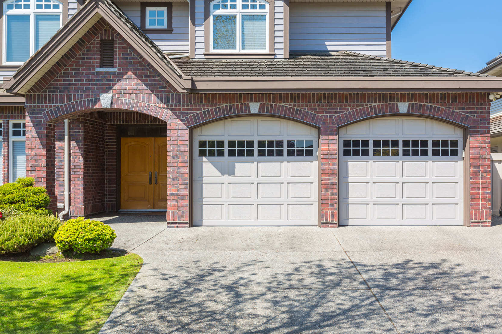 House with a two-car garage typical of homes for sale in Bowmanville